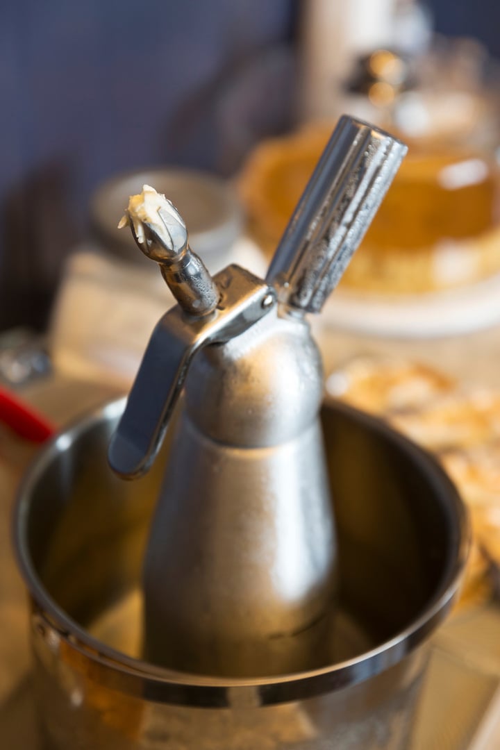 Whipping cream dispenser in ice bucket